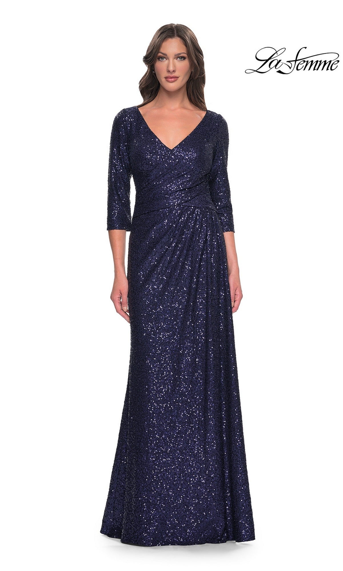 A woman wears a navy Long Formal Dress: La Femme 30879 featuring a V-neck, three-quarter length sleeves, and a floor-length silhouette.